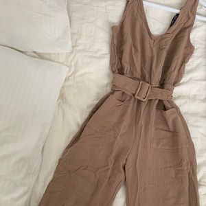 Tan jumpsuit with buckle detail